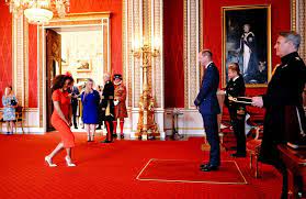 Giddy Mel B receives her MBE for services to domestic violence