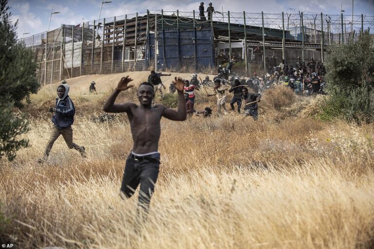5 die as more than 2,000 migrants storm fence into Spanish enclave bordering Morocco in chaotic scenes at the EU’s only land border in Africa