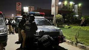 As armed men storm the Karachi police station, explosions can be heard