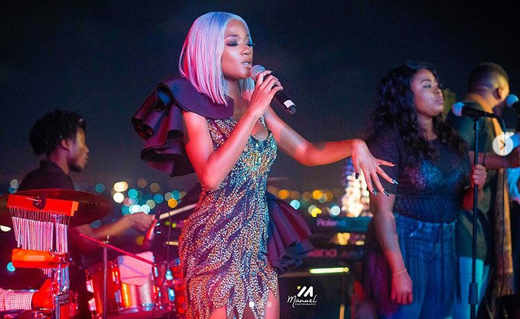 Efya performing with a live band